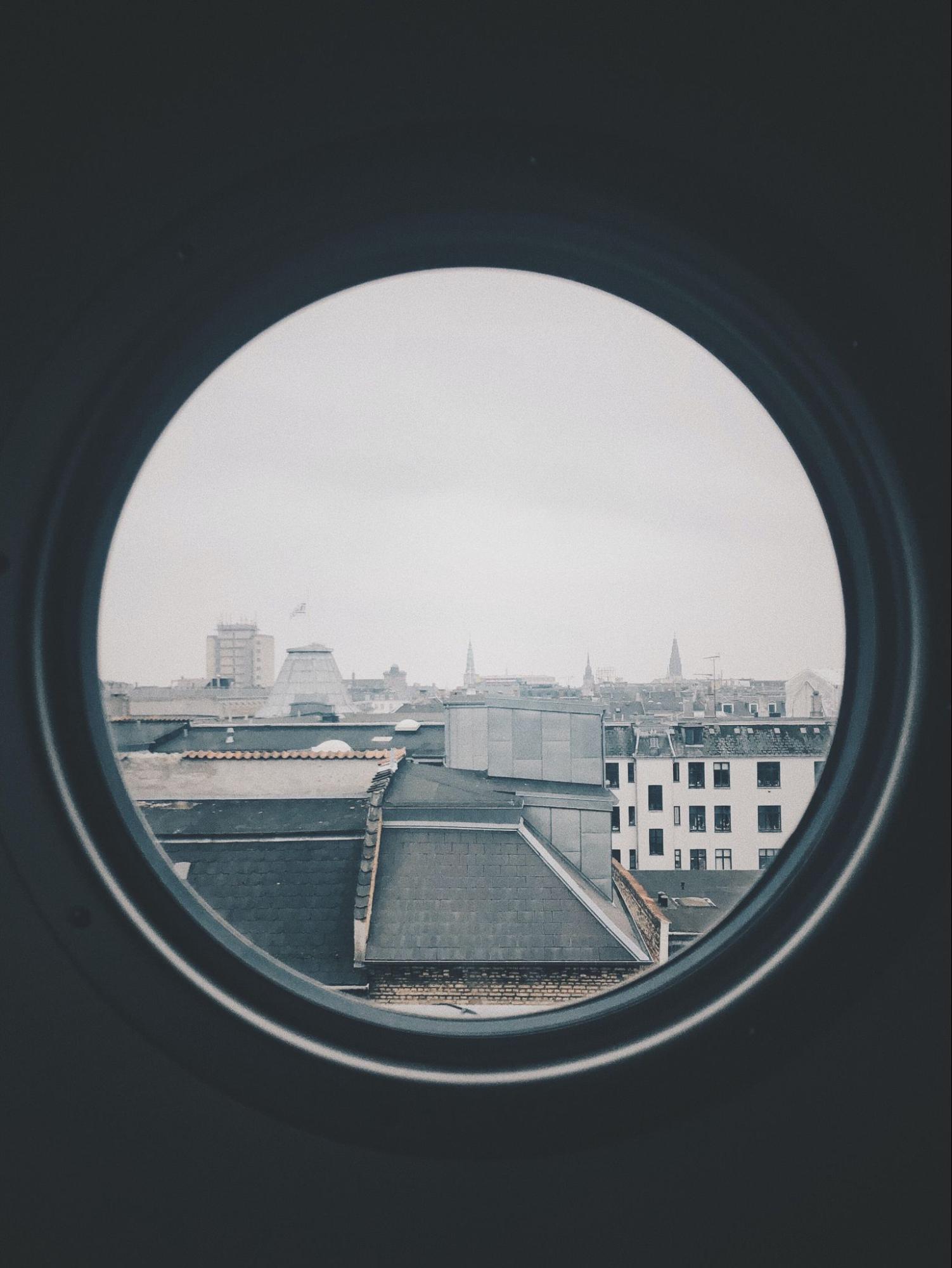 Cityscape through a round window